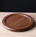 Close-up of single Oakstead walnut coaster showing circular groove